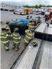 Firefighters and rolled over car