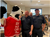 Cow fire mascot and firefighters