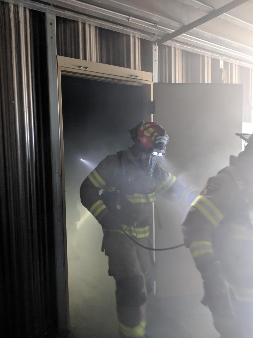 Firefighters entering a building