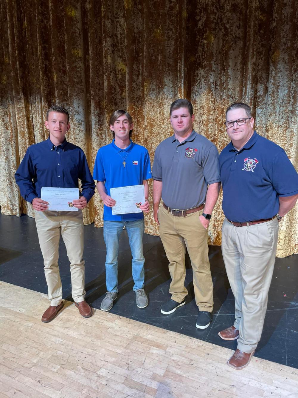 Fire staff and students holding certificates