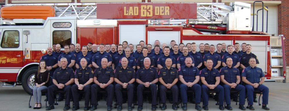 Fire staff by fire truck