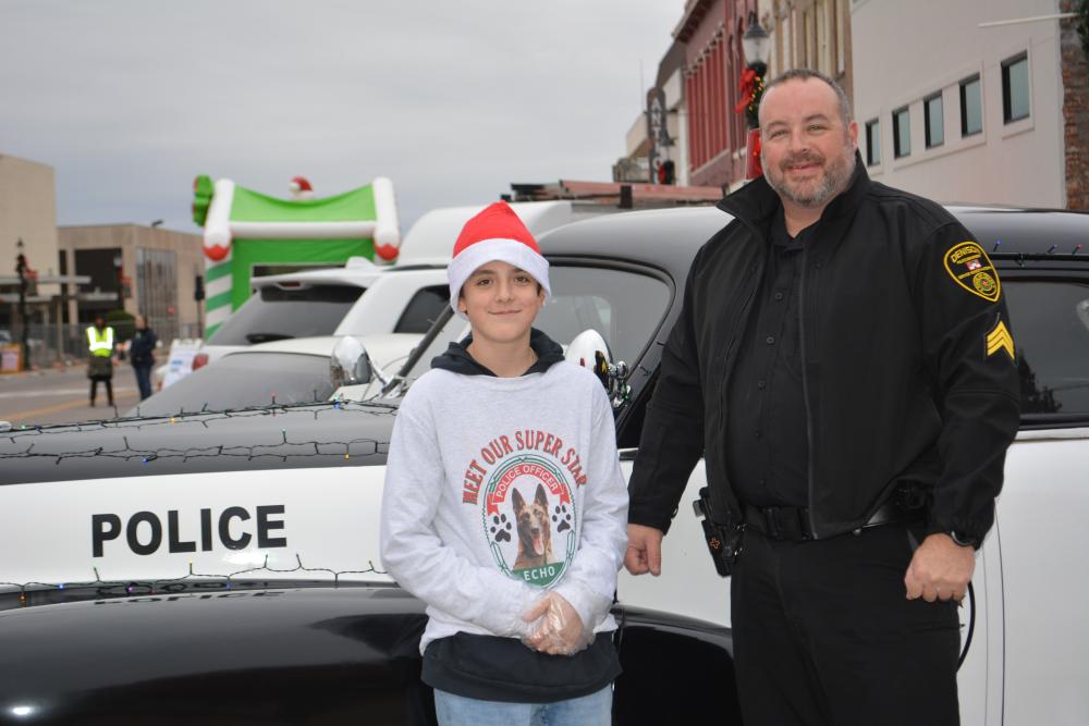 Police Officer and Child Wearing a Santa Hat