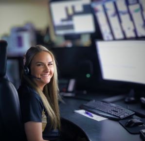 Woman sitting in front of computers